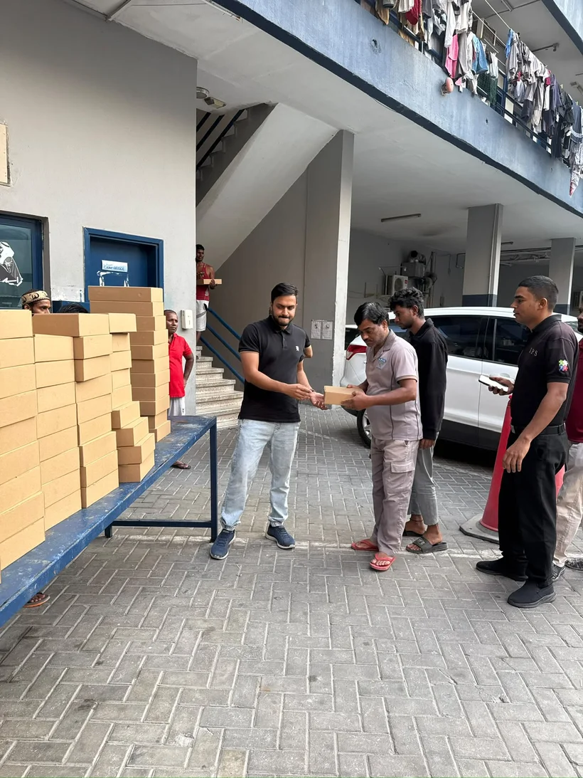 Public Kitchen team handing out boxed meals to workers
